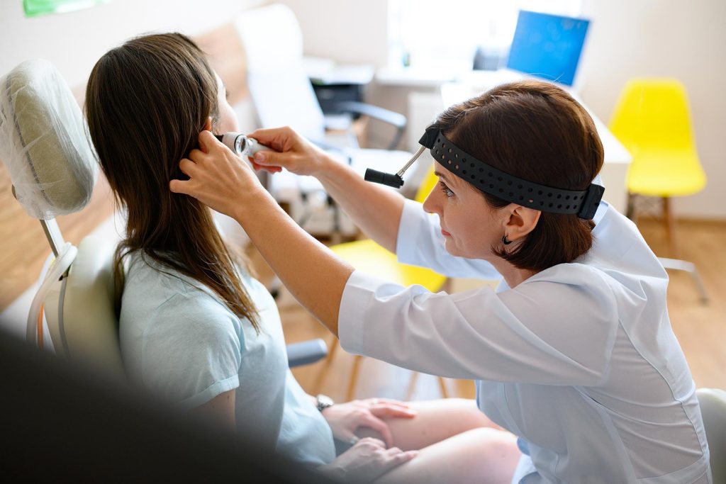 female-ent-doctor-and-patient-in-office-ear-exam-2021-08-29-07-38-46-utc.jpg